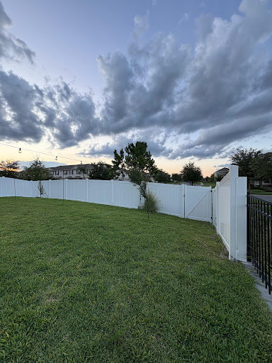 White vinyl privacy fence around a backyard