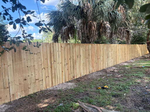 Long wood privacy fence along a property line