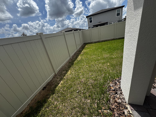 White vinyl privacy fence along a side yard